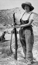 woman civilian stands guard with a rifle during the Spanish Civil War