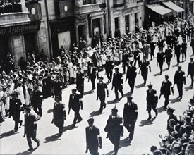 Militia men march through a town in Spain during the Spanish Civil War