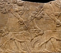 relief showing huntsmen with hounds in a garden. Assyrian, about 645-635 BC From Nineveh