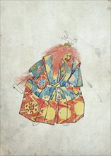 A clown wearing colourful costume and mask