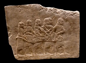Wall frieze depicting servants carrying dead lion. Assyrian, about 645-635 BC From Nineveh. Iraq