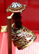 part of the boss from a shield, the lid to a Christian chalice, or the stopper to a drinking horn. from the Staffordshire Hoard. Anglo-Saxon. 7th or 8th centuries