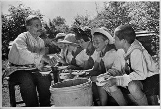 USSR Children on a Soviet collective farm, tasting honey