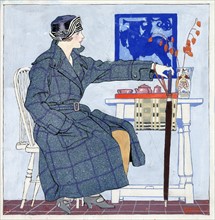 Young woman sitting beside table holding umbrella by Edward Penfield