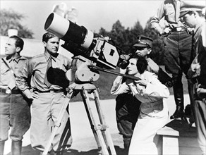 Photograph of Leni Riefenstahl looking through the lens of a large camera prior to filming the 1934 Nuremberg Rally in Germany