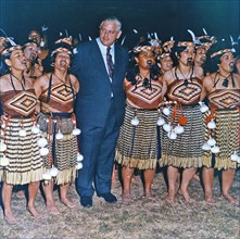 Colour photograph of Rt Hon Norman Kirk with a Maori Cultural Group