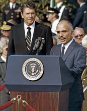 Photograph of King Hussein, addressing an audience at the White House with President Ronald Reagan