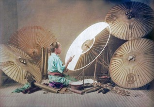 Hand coloured photograph of Kusakabe Kimbei, umbrella maker