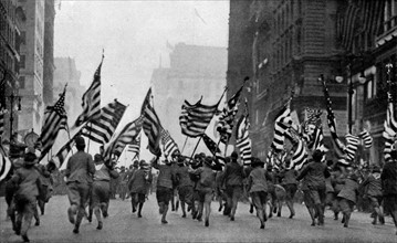 Photograph of boy scouts charging with flags during the parade up 5th Avenue, New York