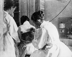 Photograph of a female doctor listening to a patient's lungs, Korea