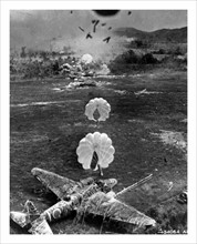Photograph of a Mitsubishi Ki-21 under attack on airfield