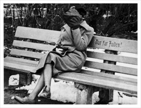 Photograph of a Jewish woman in Austria sitting on a bench marked “Only for Jews.”