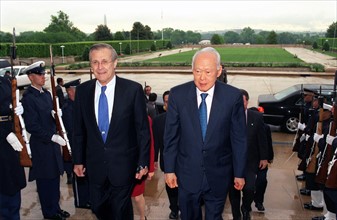 Photograph of Secretary of Defense Donald H. Rumsfeld escorting Senior Minister Lee Kuan Yew,