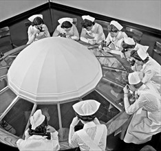 Photograph of student nurses observing an operation