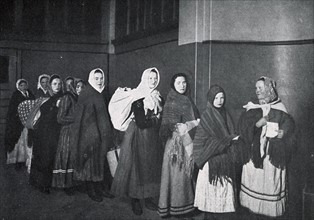 Immigrants arrive at US customs at Ellis Island, New York USA 1910