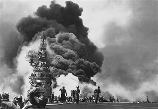 USS Bunker Hill hit by two kamikaze pilots, during the Battle of Okinawa, Japan 1945