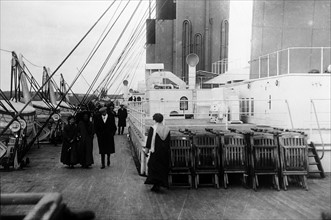 Passengers walk on the deck of the SS Titanic 1912