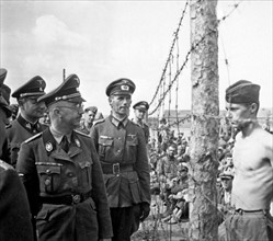 SS Chief Heinrich Himmler walks through a t prisoner of war camp for Russian prisoners of war.