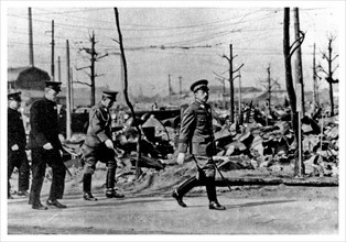 Japanese Emperor Hirohito walks through the ruins of Tokyo in the later months of World war two.