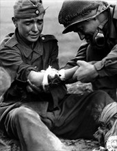 Captured German soldier is treated for his wounds
