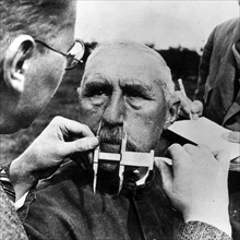A man having his nose measured during Aryan race determination tests under Nazi Germany's Nuremberg Laws that was applied to determine whether a person was considered a 'Jew'