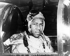 Photograph of Jesse L. Brown in the cockpit of a F4U-4 Corsair fighter