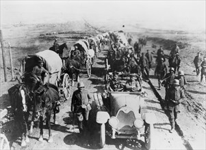 German officers in an automobile, with a convoy of wagons;World war one 1916