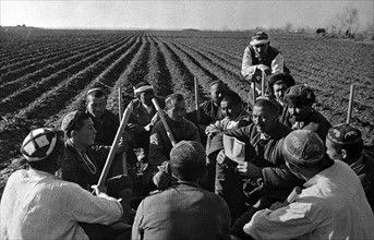 Photograph of Uzbek collective farmers discussing work of spring sowing in the USSR