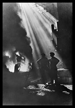 Photograph of men watching molten steel being poured into pigs in the USSR