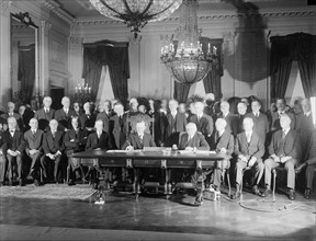 Photograph of President Calvin Coolidge signing the Kellogg Treaty