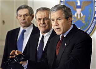 Photograph of Paul wolfowitz, Donald Rumnsfeld and George H W Bush