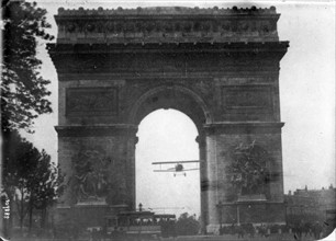piloting a Nieuport 11 Bébé under the Arch of the through the Arc de Triomphe