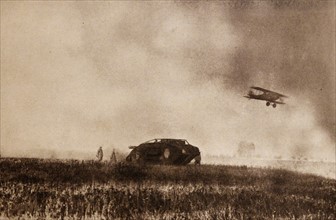 British tank with soldiers and aircraft in escort