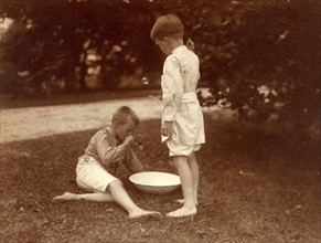 American boys playing in a garden with bubbles