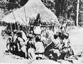 Kikuyu tribesmen gather to prepare for hunting