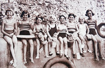 children enjoying time at a beach in England in the period just before world war two. 1938
