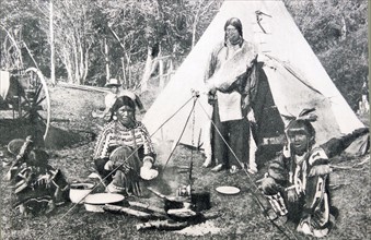 Native American Indians in front of a wigwam or tepee 1900