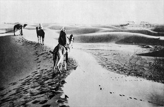 North African Arabs cross the Sahara desert by camel 1930