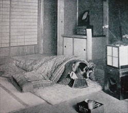 Traditional Japanese bedroom with woman sleeping using a head support