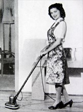 Photograph of a housewife using floor buffer