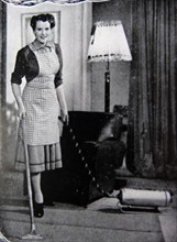 Photograph of a housewife using a hoover
