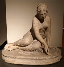 Marble statue of a young Roman girl playing Knucklebones