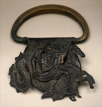 Bronze handle of a vessel decorated with repousse relief