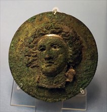 Bronze mirror cover with the head of a maenad or Ariadne
