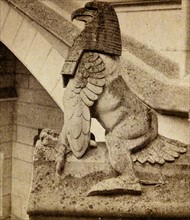 a stone figure astride the steps at the entrance of the Château de Pierrefonds