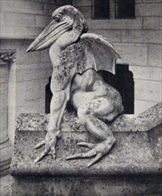 a stone figure astride the steps at the entrance of the Château de Pierrefonds