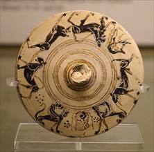 Lid from a pyxis with animals and a cuirass from Greece