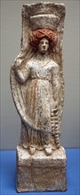 Terracotta figure of a woman wearing a chiton and Polos crown