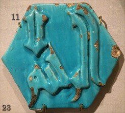 Calligraphic relief tile with turquoise glaze