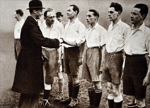 Prince Albert shaking hands of football players